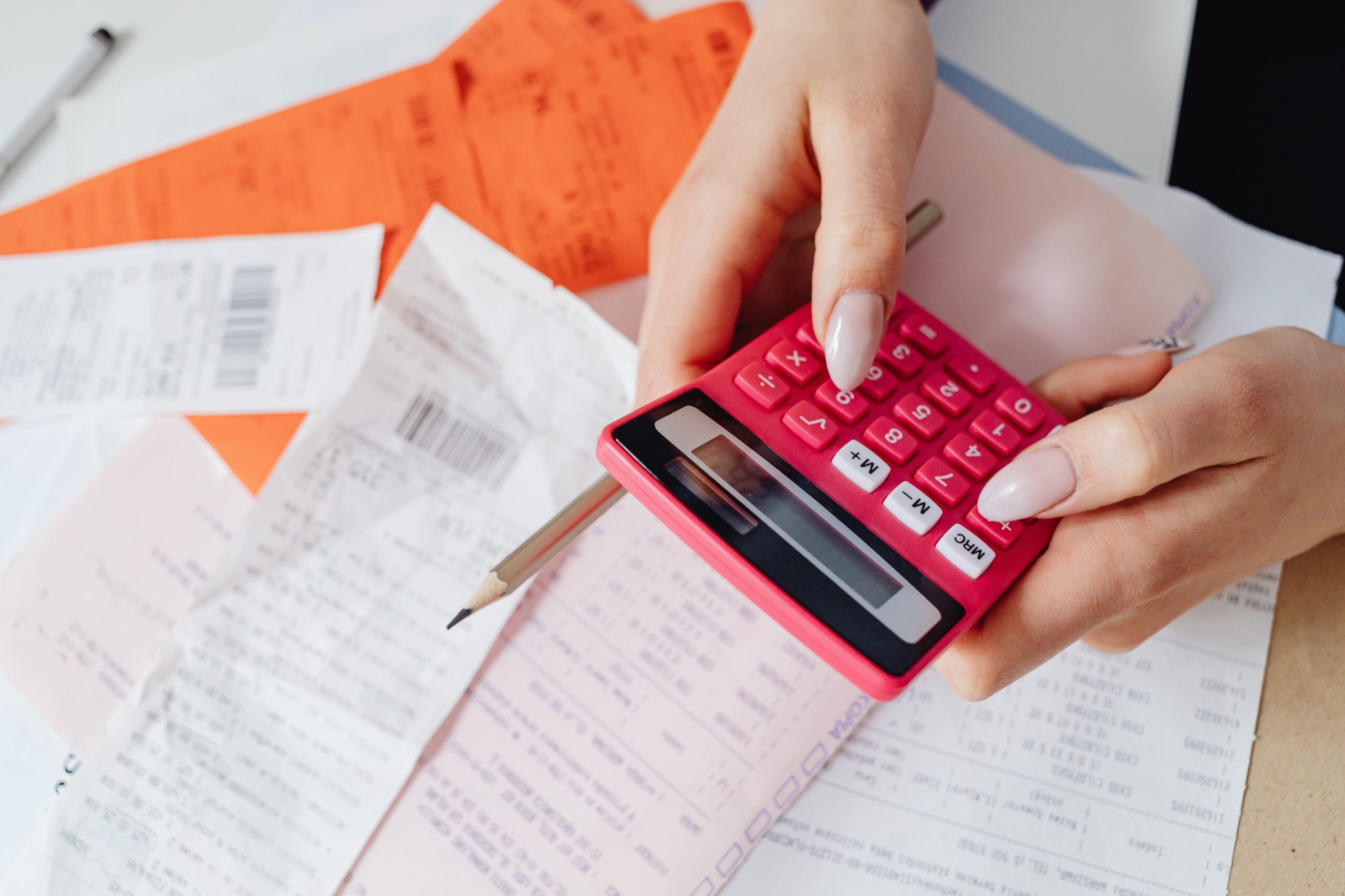 Unopened bills and a phone on a table
